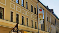 A yellow building with a baumit banner 