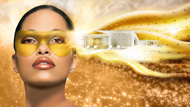 A woman with a gold mask on a gold background next to a white building